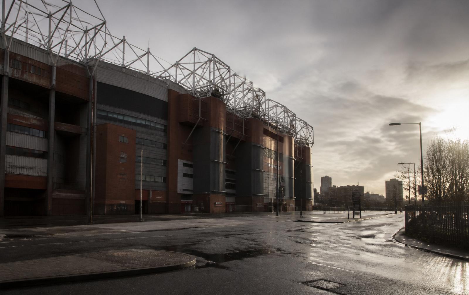 Exterior of the existing Old Trafford stadium on a wet overcast morning